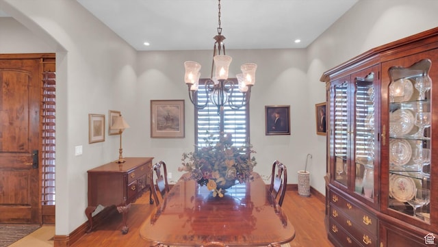 2847 W Amini Way S, Jordan, UT 84095 - dining area featuring baseboards, arched walkways, a notable chandelier, recessed lighting, and wood finished floors