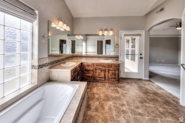 full bathroom featuring a sink, visible vents, a bath, and a ceiling fan