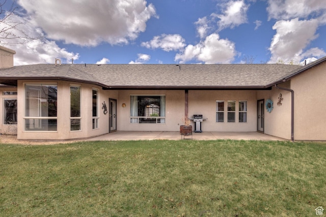rear view of property featuring a patio area, stucco siding, and a lawn