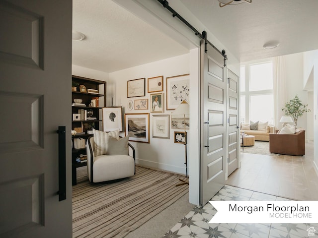 13678 S Langdon Dr Unit 2315, Riverton, UT 84096 - sitting room with baseboards, a barn door, and a textured ceiling