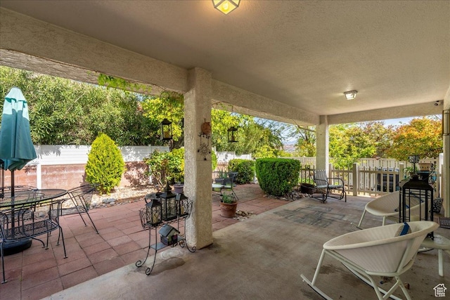 view of patio with outdoor dining space and a fenced backyard