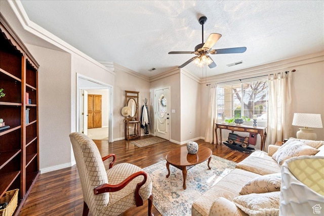 living area featuring a ceiling fan, visible vents, a textured ceiling, and dark wood-style floors