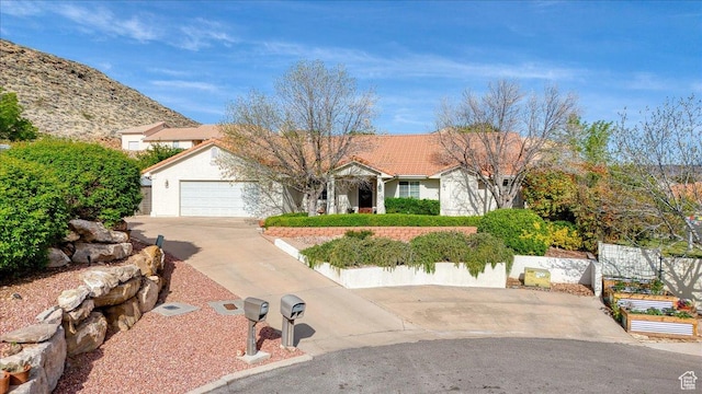 single story home with concrete driveway, stucco siding, and a garage