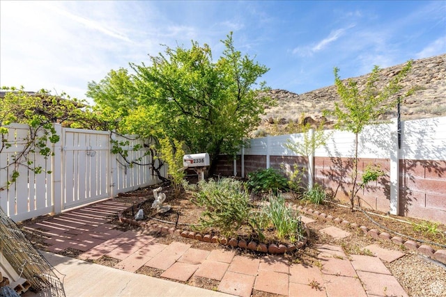 view of patio / terrace featuring fence and a gate