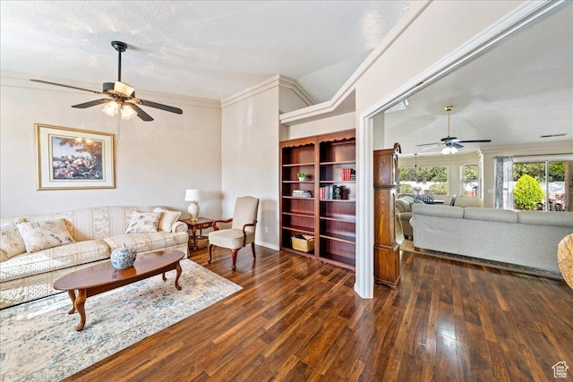 living area with hardwood / wood-style floors, vaulted ceiling, a ceiling fan, and crown molding
