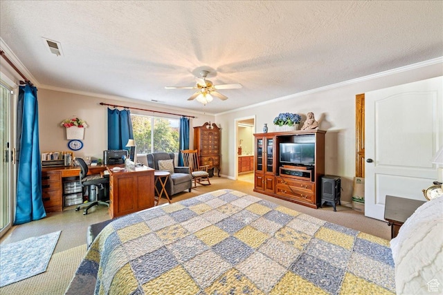 bedroom with visible vents, ornamental molding, ceiling fan, a textured ceiling, and ensuite bath