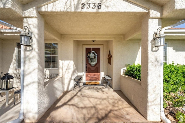 property entrance featuring stucco siding