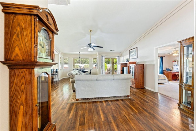living room featuring dark wood-type flooring, ornamental molding, baseboards, and a ceiling fan