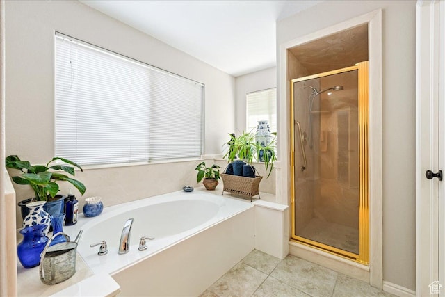 full bathroom with tile patterned floors, a bath, and a stall shower