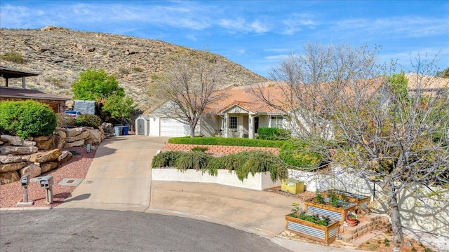 view of front facade with concrete driveway and a garage