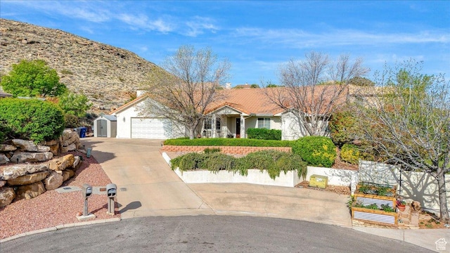 single story home featuring stucco siding, fence, a tile roof, an attached garage, and driveway