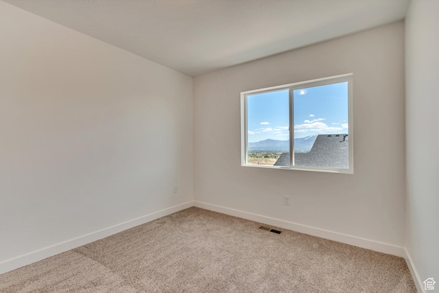 6864 S Static Peak Dr Unit 258, West Jordan, UT 84081 - empty room featuring visible vents, baseboards, and light carpet