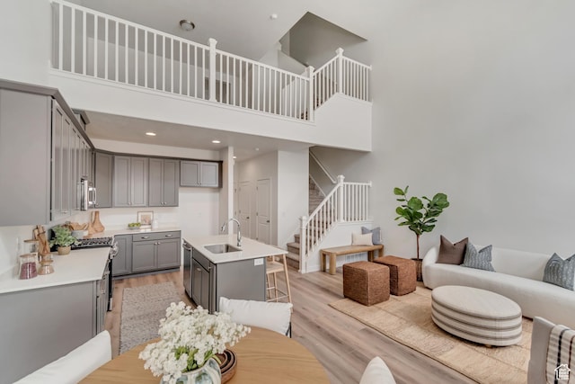 6864 S Static Peak Dr Unit 258, West Jordan, UT 84081 - interior space featuring stairs, light wood-style flooring, recessed lighting, and a high ceiling