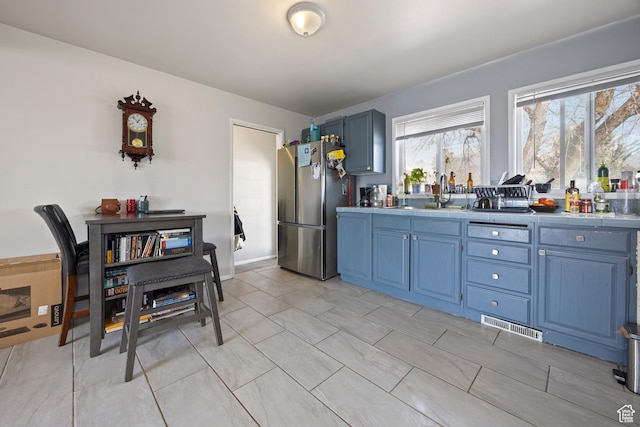 4622 S 375 E, Washington Terrace, UT 84405 - kitchen with blue cabinetry, visible vents, a sink, and freestanding refrigerator