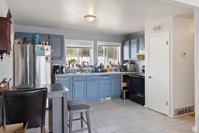 4622 S 375 E, Washington Terrace, UT 84405 - kitchen featuring freestanding refrigerator, visible vents, under cabinet range hood, a sink, and black electric range oven