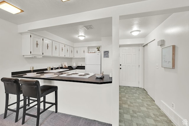 1298 Lorl Ln Unit 2, Ogden, UT 84404 - kitchen featuring white appliances, a peninsula, visible vents, a sink, and dark countertops