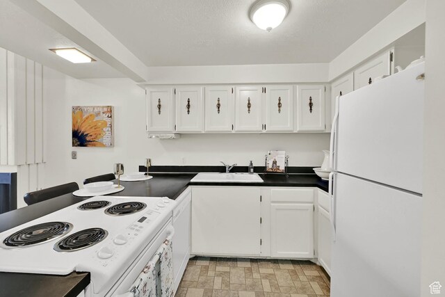 1298 Lorl Ln Unit 2, Ogden, UT 84404 - kitchen with white cabinetry, dark countertops, and white appliances