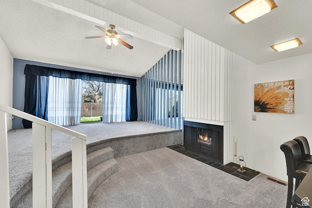 1298 Lorl Ln Unit 2, Ogden, UT 84404 - interior space featuring carpet, a textured ceiling, a large fireplace, visible vents, and lofted ceiling