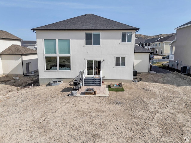 2888 E Carriage Hill Dr, Eagle Mountain, UT 84005 - back of house with cooling unit, a shingled roof, stucco siding, and a patio area