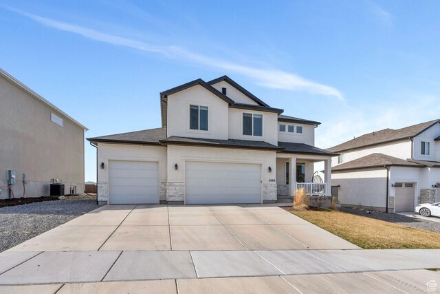 2888 E Carriage Hill Dr, Eagle Mountain, UT 84005 - view of front facade featuring stucco siding, driveway, stone siding, a porch, and central AC