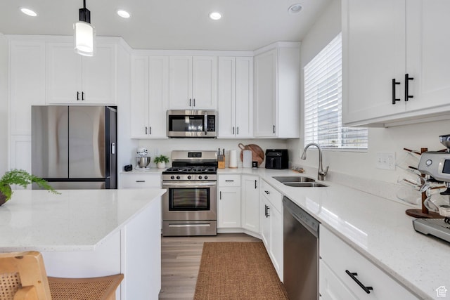 2888 E Carriage Hill Dr, Eagle Mountain, UT 84005 - kitchen with appliances with stainless steel finishes, a sink, white cabinets, and recessed lighting