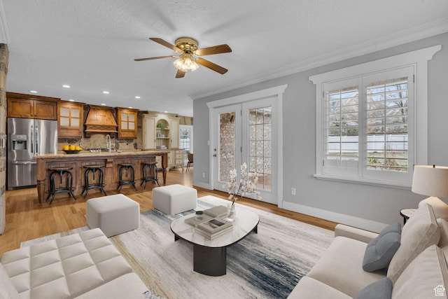 307 E 680 N, Lindon, UT 84042 - living room with light wood-style floors, ornamental molding, baseboards, and a ceiling fan