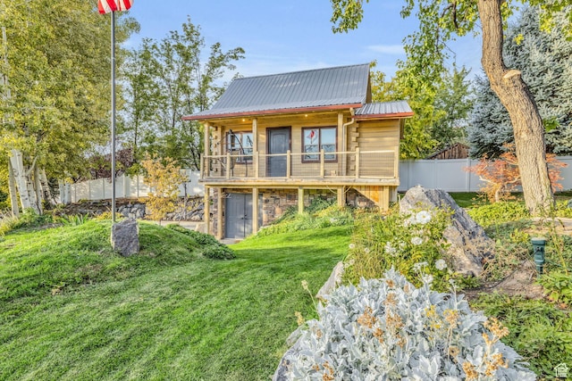 307 E 680 N, Lindon, UT 84042 - rear view of house featuring a yard, metal roof, stone siding, and fence