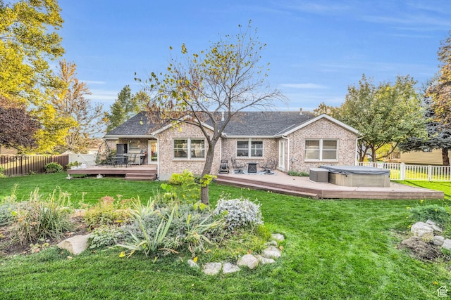 307 E 680 N, Lindon, UT 84042 - back of property with brick siding, a fenced backyard, a hot tub, a deck, and a lawn