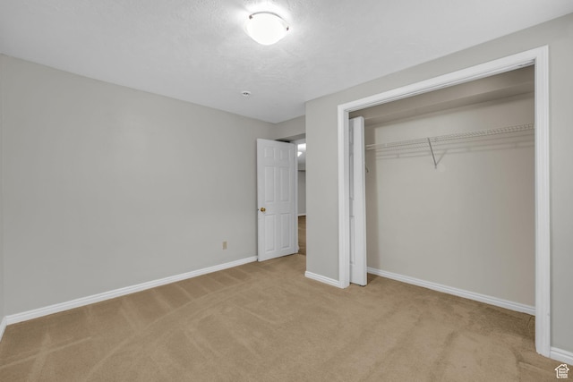 307 E 680 N, Lindon, UT 84042 - unfurnished bedroom featuring carpet flooring, a closet, baseboards, and a textured ceiling