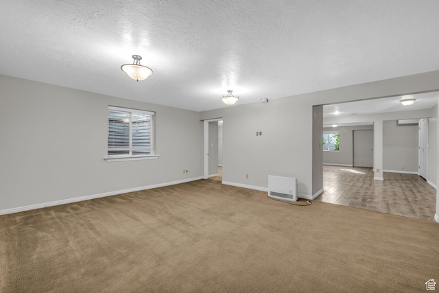 307 E 680 N, Lindon, UT 84042 - carpeted empty room featuring a textured ceiling, baseboards, and heating unit