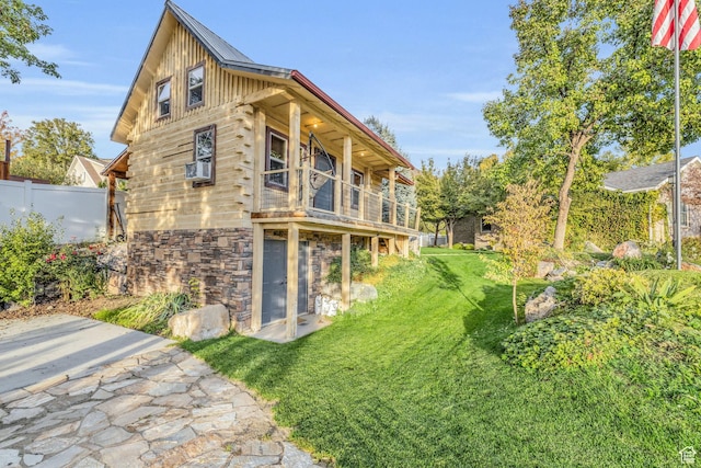 307 E 680 N, Lindon, UT 84042 - rear view of house featuring stone siding, a lawn, board and batten siding, fence, and cooling unit