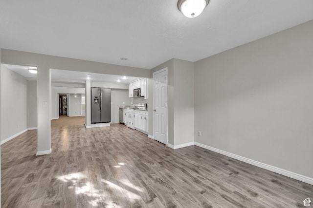 307 E 680 N, Lindon, UT 84042 - unfurnished living room with light wood-style flooring and baseboards