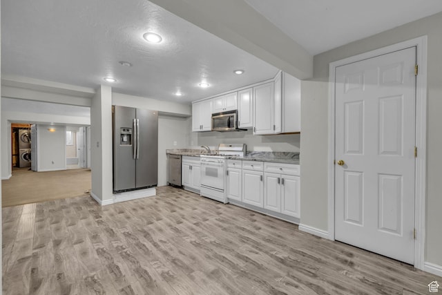307 E 680 N, Lindon, UT 84042 - kitchen with light stone countertops, light wood-style floors, white cabinetry, and appliances with stainless steel finishes