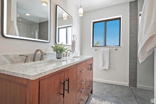 579 E 13th Ave, Salt Lake City, UT 84103 - bathroom with tiled shower, double vanity, a sink, and baseboards