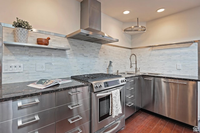 579 E 13th Ave, Salt Lake City, UT 84103 - kitchen with wall chimney exhaust hood, modern cabinets, dark wood-style flooring, dark stone counters, and stainless steel appliances