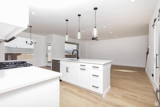 4153 El Capitan Way, St George, UT 84790 - kitchen featuring a sink, open floor plan, light wood-type flooring, ceiling fan with notable chandelier, and pendant lighting