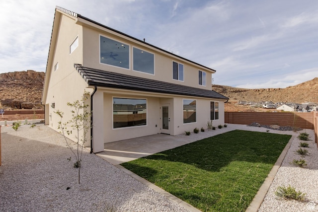 4153 El Capitan Way, St George, UT 84790 - back of property with stucco siding, a mountain view, a patio area, a yard, and fence