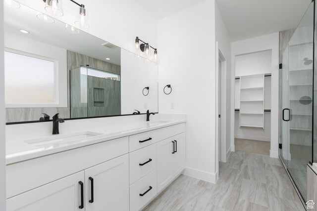 4153 El Capitan Way, St George, UT 84790 - full bath featuring double vanity, baseboards, a sink, and a stall shower