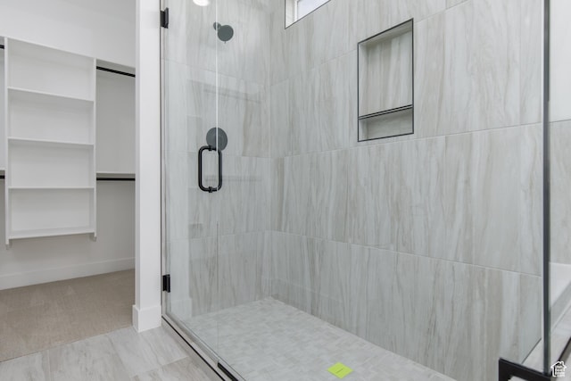 4153 El Capitan Way, St George, UT 84790 - bathroom with a spacious closet, a tile shower, and baseboards