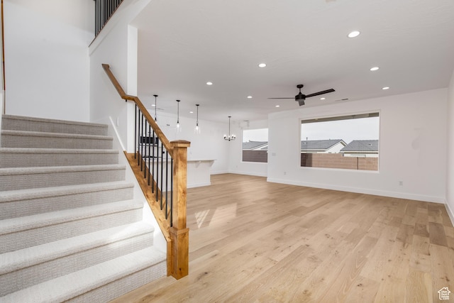 4153 El Capitan Way, St George, UT 84790 - stairs with wood finished floors, ceiling fan with notable chandelier, baseboards, and recessed lighting