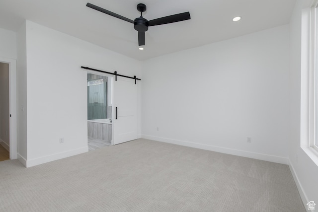 4153 El Capitan Way, St George, UT 84790 - unfurnished room featuring baseboards, a ceiling fan, light colored carpet, and a barn door