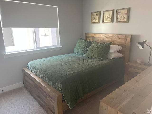 carpeted bedroom featuring baseboards