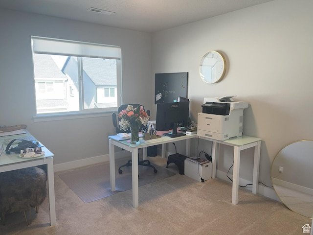 carpeted office space featuring baseboards and visible vents