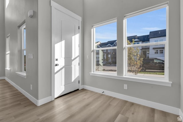 entryway featuring wood finished floors and baseboards