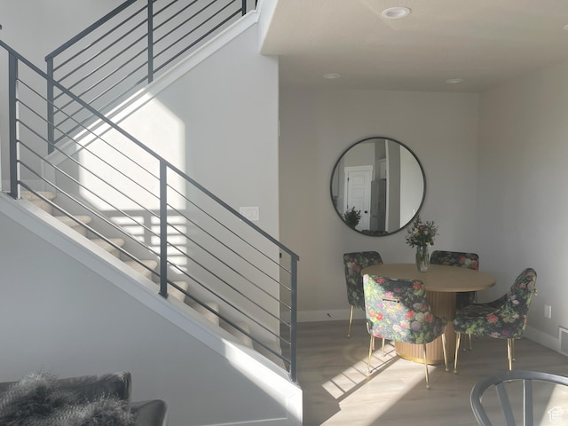 stairway featuring visible vents, baseboards, and wood finished floors