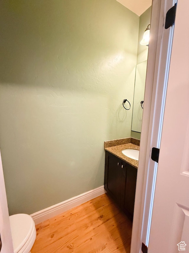 141 E 620 S, Smithfield, UT 84335 - half bathroom featuring vanity, baseboards, toilet, and wood finished floors