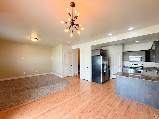 141 E 620 S, Smithfield, UT 84335 - kitchen with a sink, light wood-style flooring, an inviting chandelier, and stainless steel appliances