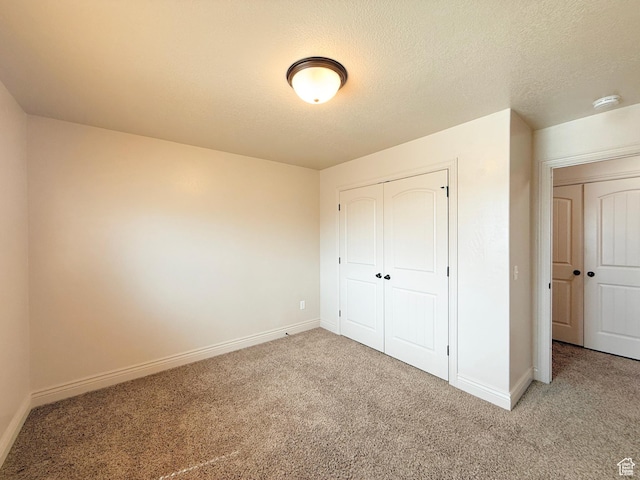 141 E 620 S, Smithfield, UT 84335 - unfurnished bedroom with a textured ceiling, a closet, baseboards, and carpet floors
