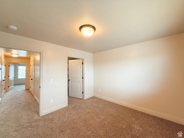 141 E 620 S, Smithfield, UT 84335 - unfurnished bedroom with light carpet, baseboards, and a textured ceiling