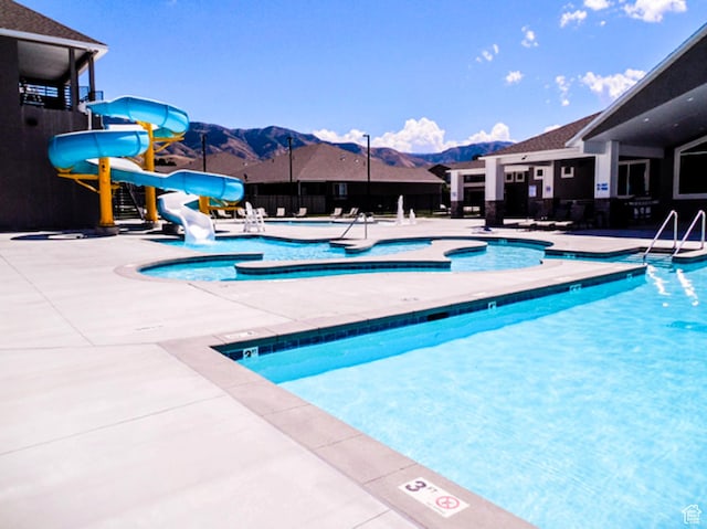 141 E 620 S, Smithfield, UT 84335 - community pool featuring a patio, a mountain view, a water slide, and a hot tub